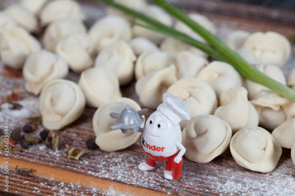 real, delicious, Russian dumplings on the table, with fresh herbs and spices, for cooking design.	