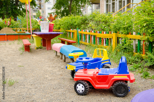 sandy playground with plastic big car toys