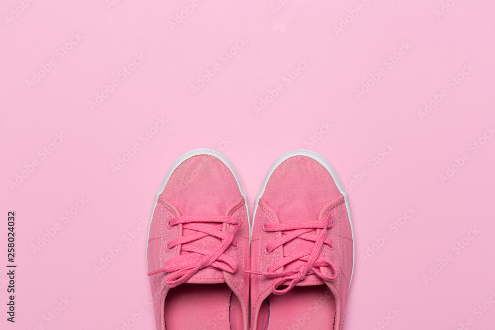 Pink shoes on a pastel background. Top view. Free space for text.