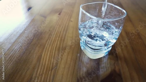 Fill a cup of water in a wood table photo