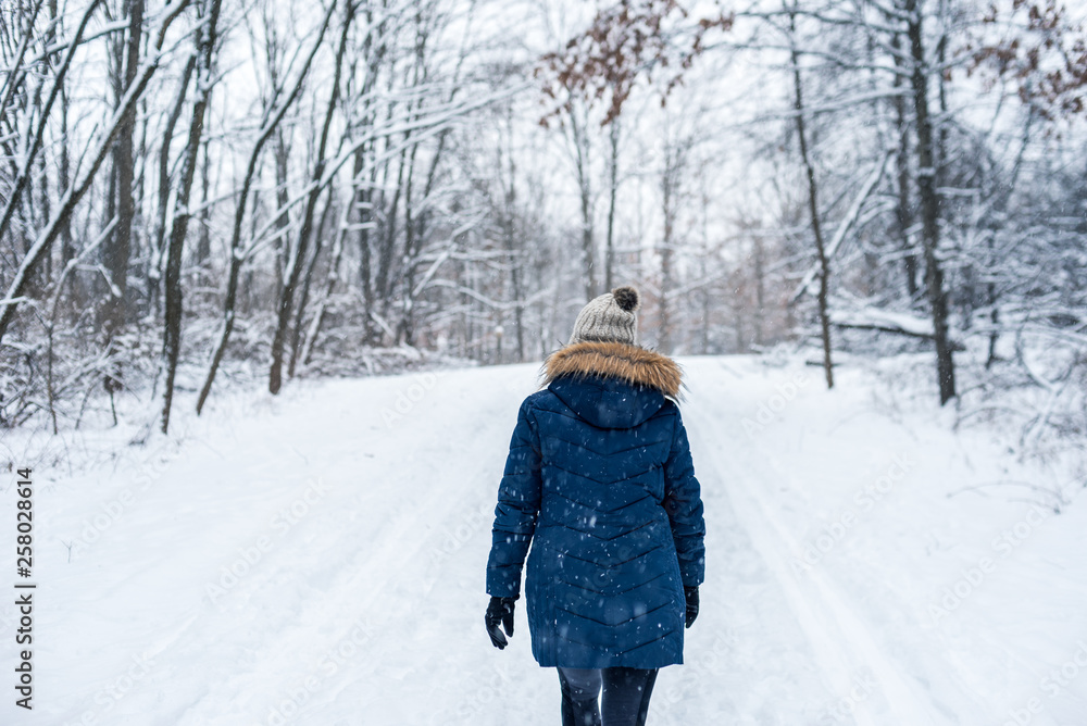 woman walking in winter woods