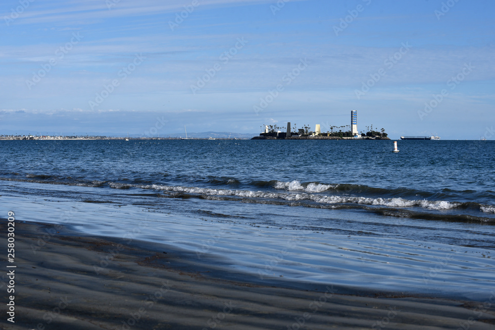 Oil drilling wasted darken the shoreline at Alamitos Beach