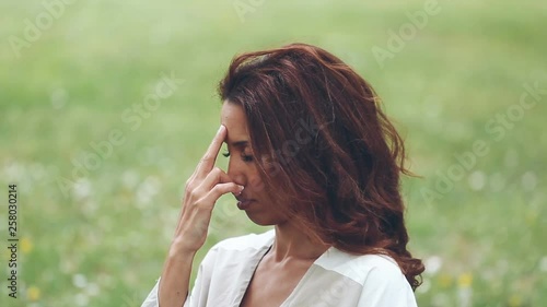 attractive woman practicing yoga in nature