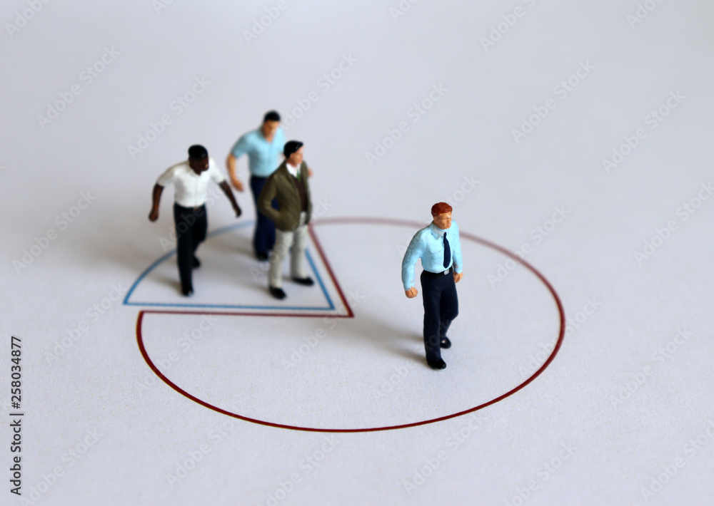 Miniature people standing on a circle graph. Miniature people standing on a circle graph.