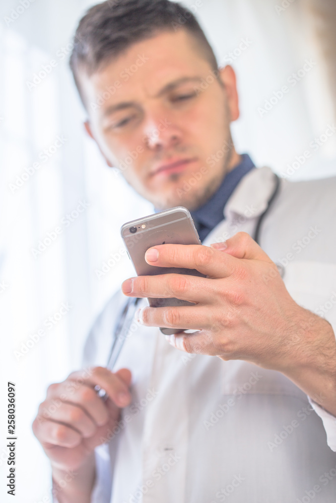 Doctor using a mobile phone notes scan brain results. Concepts of medical, radiology, radiologic, ct scanner, mri scan, radiologist. Doctor using a mobile phone notes scan brain results. Concepts of medical, radiology, radiologic, ct scanner, mri scan, radiologist.
