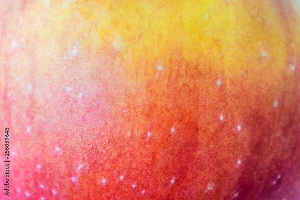 Apple yellow-red peel close-up. High-quality image is suitable for topics: healthy lifestyle, vitamins, proper nutrition, diet, summer, fresh juices. Background fruit texture.