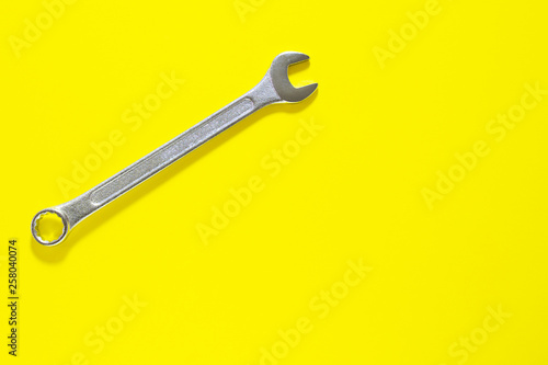 Spanner key on yellow background. Screw driver set. Background for your text and design.