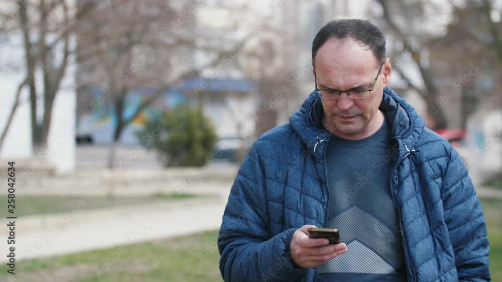 casual man standing with smartphone on the street casual man standing with smartphone on the street