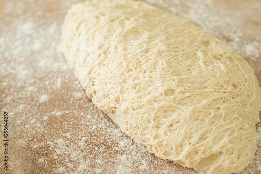 dough lying on a wooden cutting board sprinkled with flour dough lying on a wooden cutting board sprinkled with flour