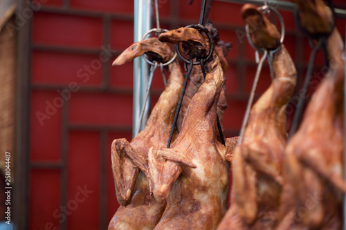 Roasted Peking ducks hanging in front of Chinese restaurant © Sakon