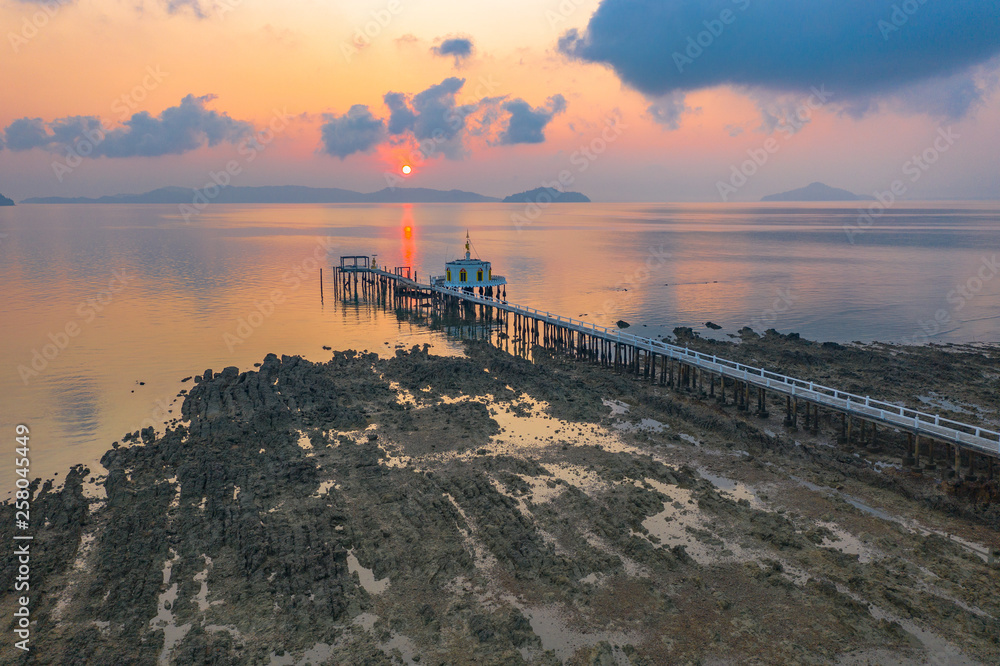 aerial view sunrise at pier of Phayam temple one landmark of Phayam island. Phayam temple is on Hin Kao gulf. .The temple is close to the shipping port. in the end of Phayam temple pier have memorial