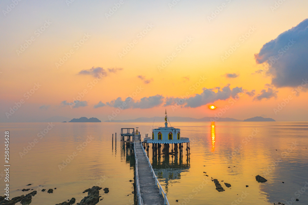 aerial view sunrise at pier of Phayam temple one landmark of Phayam island. Phayam temple is on Hin Kao gulf. .The temple is close to the shipping port. in the end of Phayam temple pier have memorial