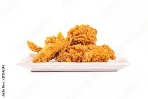 Fried chicken on white plate on white...