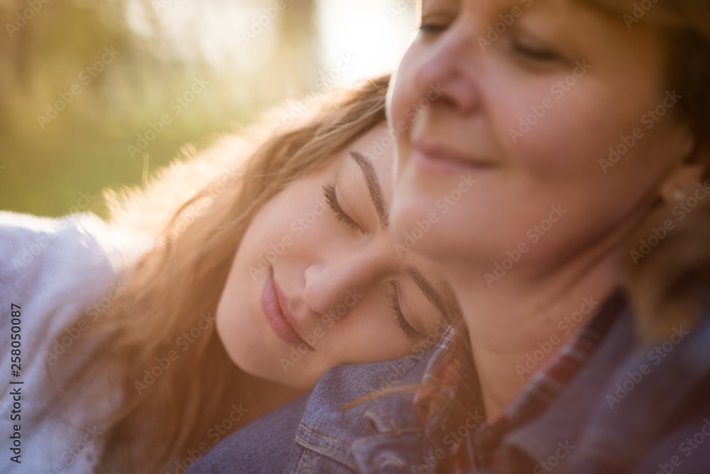 Love - senior mother with her teen daughter outdoors Love - senior mother with her teen daughter outdoors