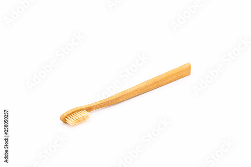 Bamboo toothbrush on white background.