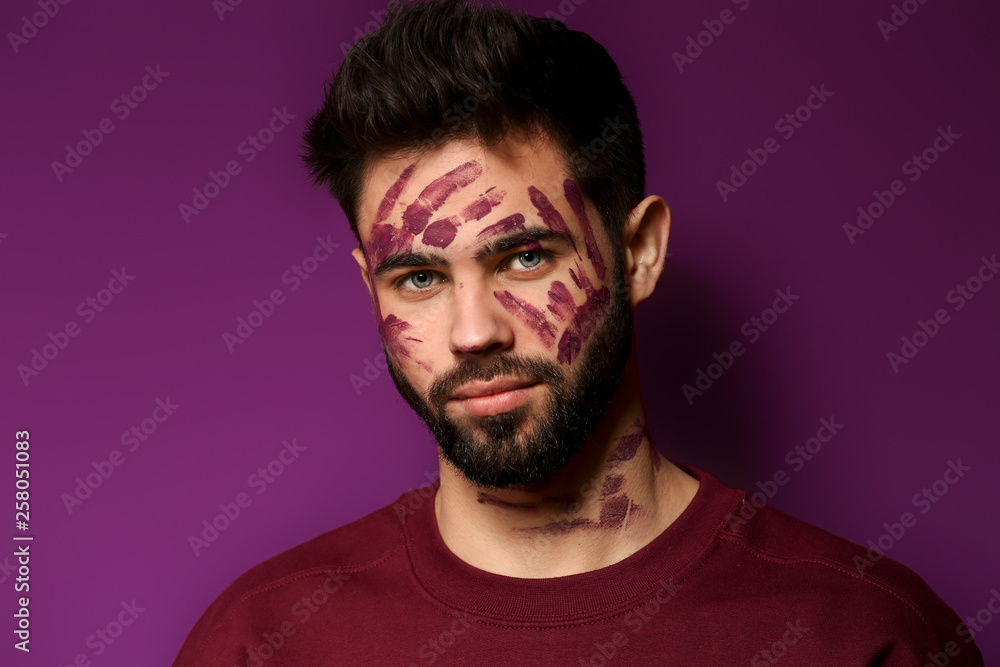 Portrait of handsome man with paint on his face against color background Portrait of handsome man with paint on his face against color background
