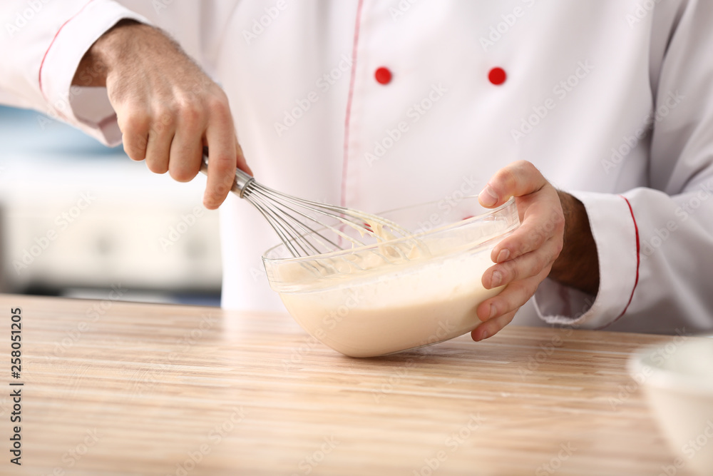 Male confectioner making dough in kitchen, closeup Male confectioner making dough in kitchen, closeup