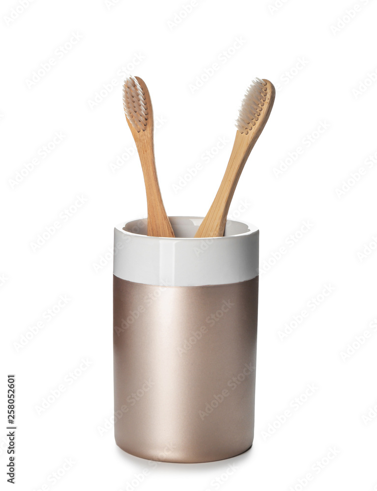Holder with toothbrushes on white background