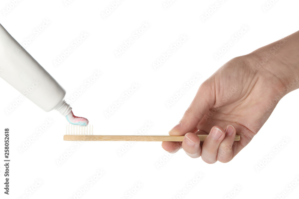 Squeezing of paste on toothbrush against white background Squeezing of paste on toothbrush against white background