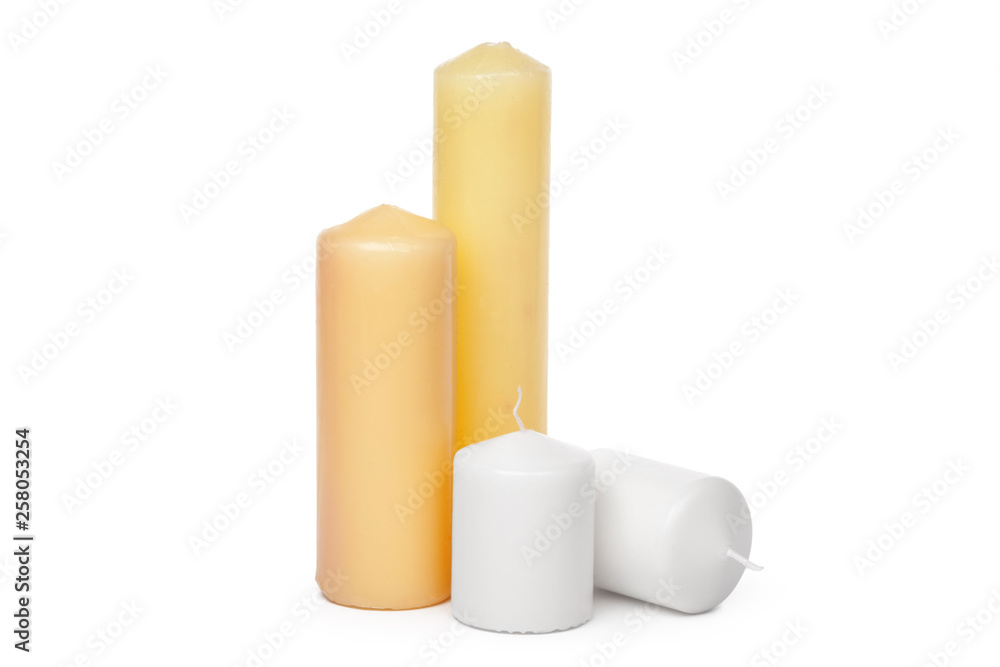 different sized candles on a white background different sized candles on a white background