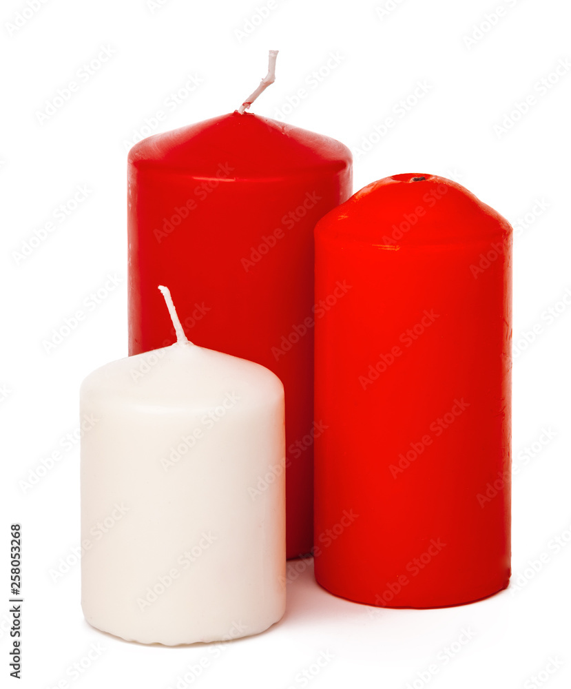 Red and white colored xmas candles isolated on white background Red and white colored xmas candles isolated on white background