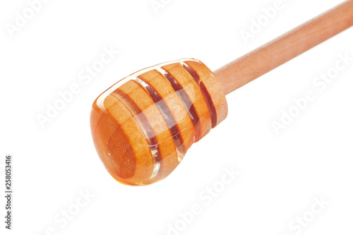 Honey stick with flowing honey isolated on white background