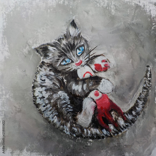Foto A kitten with blue eyes playing with a toy rocket