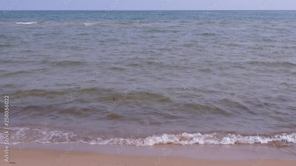 Expansive lake from sandy shoreline to horizon. Expansive lake from sandy shoreline to horizon.