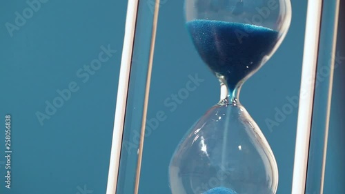 Hourglass on blue background