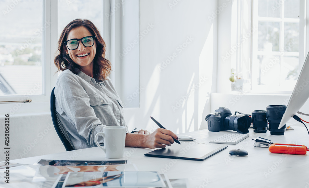 Professional photographer at her office desk Stock Photo Adobe Stock