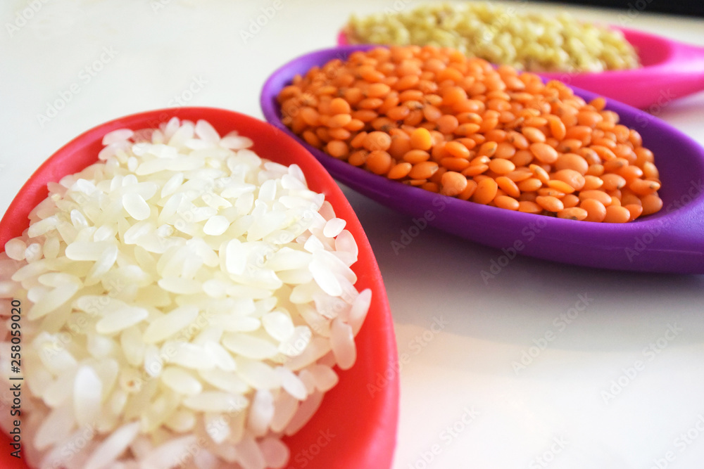 Rice, lentil, bulgur wheat in spoons