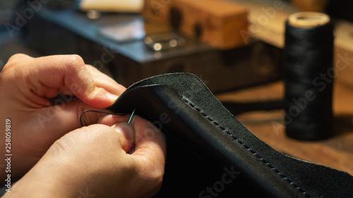Leather handbag craftsman at work in a workshop