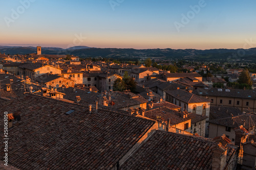 A sweeping view of the rooftops of Gubbio at sunset taken from the main Piazza Grande in the town centre