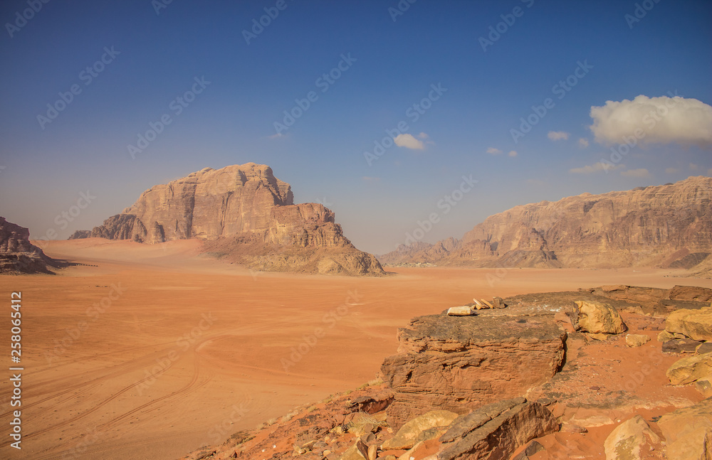 picturesque desert landscape panorama photography in sunny bright day with yellow sand dunes valley foreground and mountain rocks background 