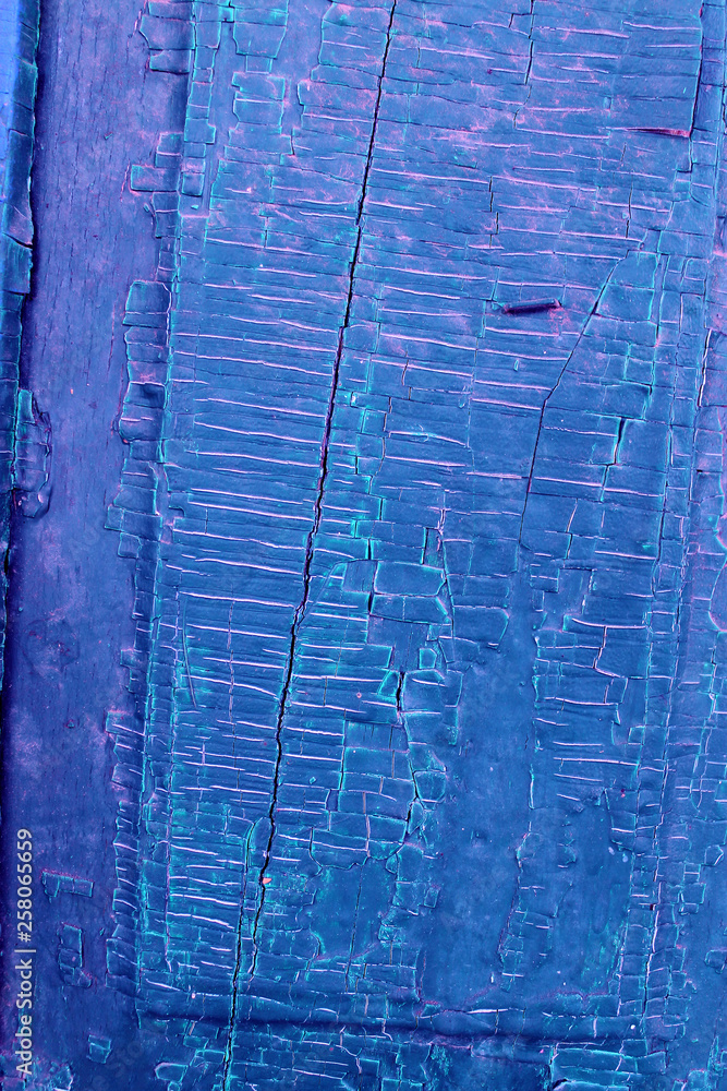 Obraz premium Old wooden background with remains of pieces of scraps of old paint on wood. Texture of an old tree, vintage wood background peeling paint. old blue board with cracked paint