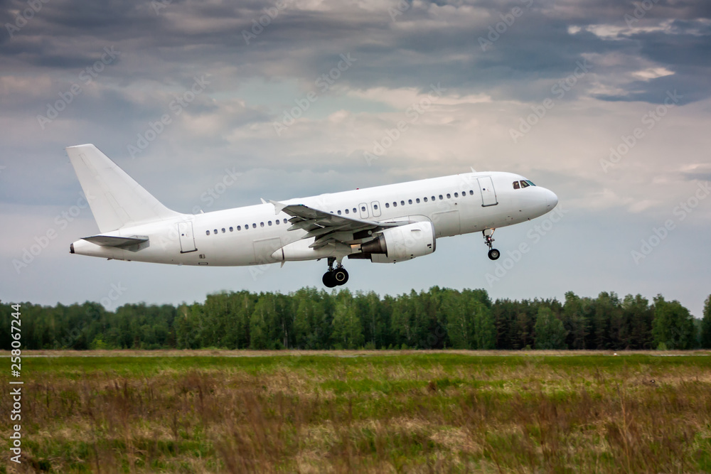 White passenger aircraft in the air on take-off White passenger aircraft in the air on take-off