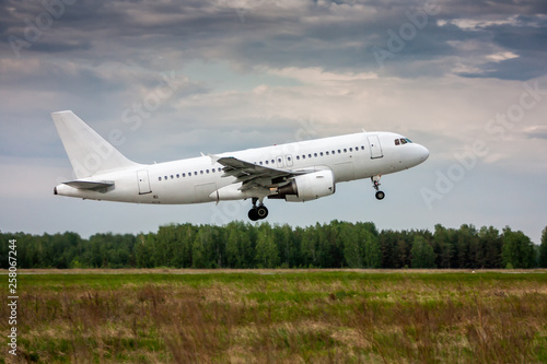 White passenger aircraft in the air on take-off