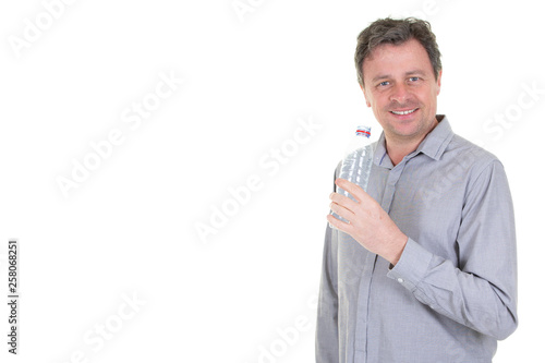 Man showing plastic bottle with cold water in white background and copy space