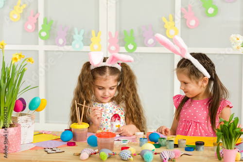 cute kids painting Easter eggs at home. adorable children prepare for easter