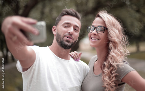 close up.smiling young couple taking selfie in city Park