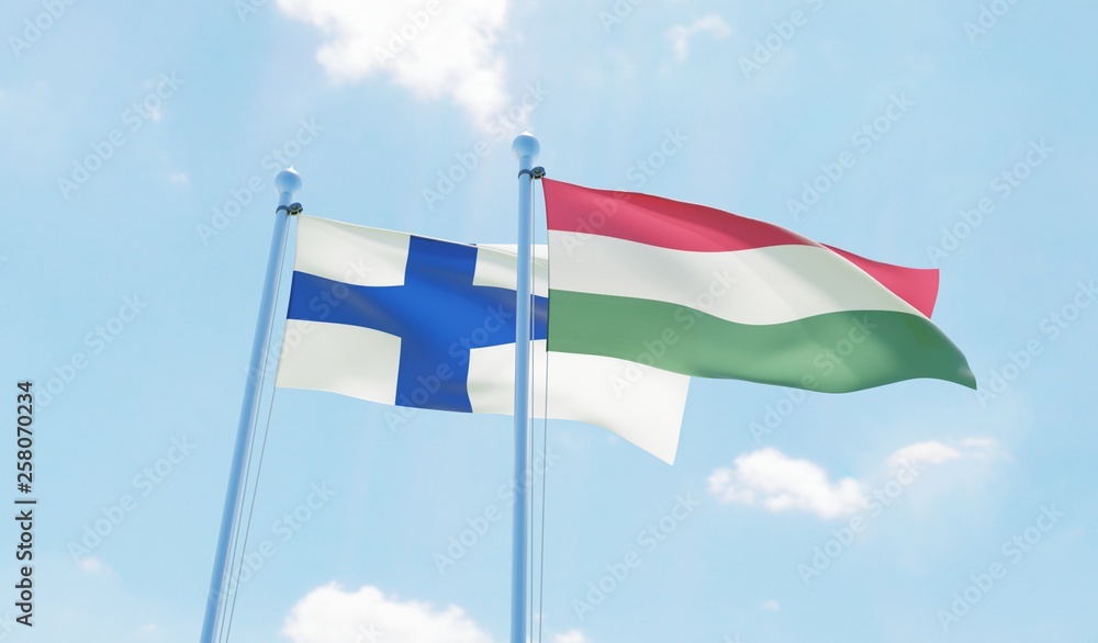 Hungary and Finland, two flags waving against blue sky. 3d image Hungary and Finland, two flags waving against blue sky. 3d image