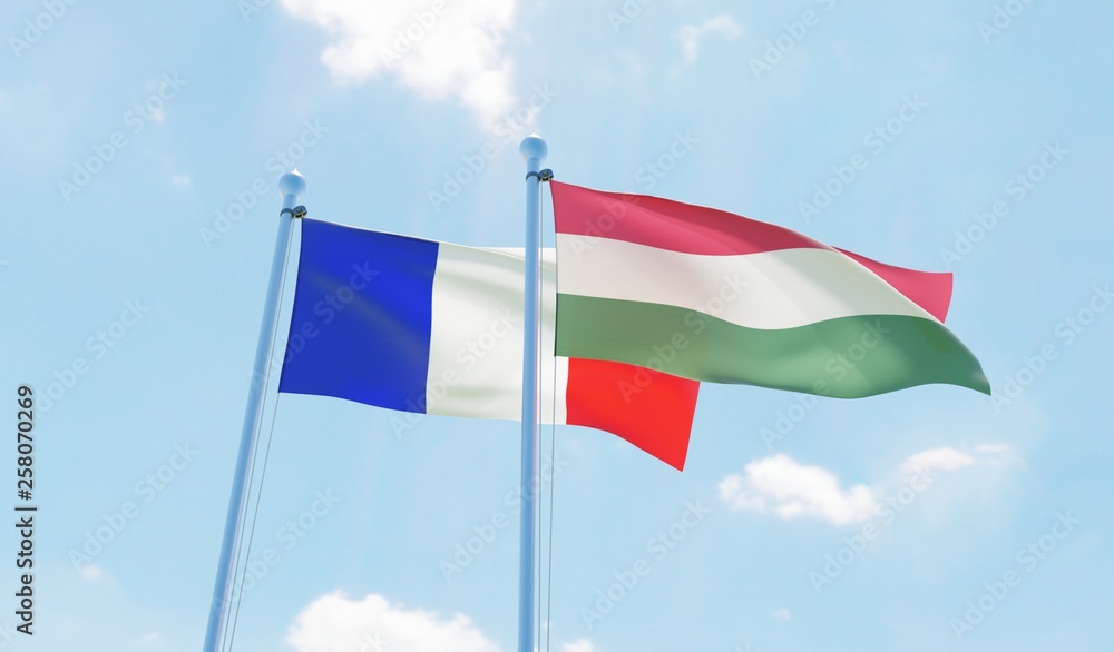 Hungary and France, two flags waving against blue sky. 3d image Hungary and France, two flags waving against blue sky. 3d image