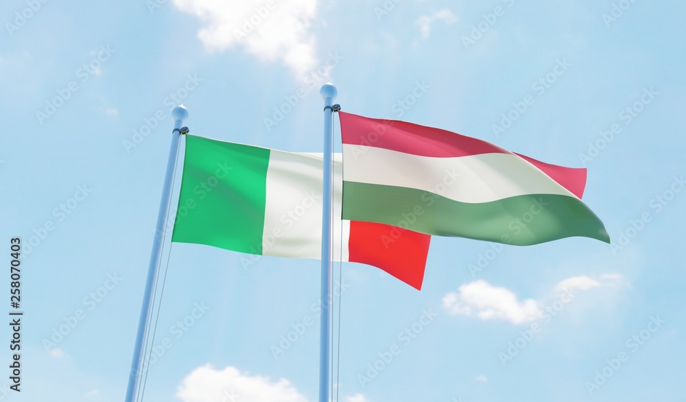 Hungary and Italy, two flags waving against blue sky. 3d image Hungary and Italy, two flags waving against blue sky. 3d image