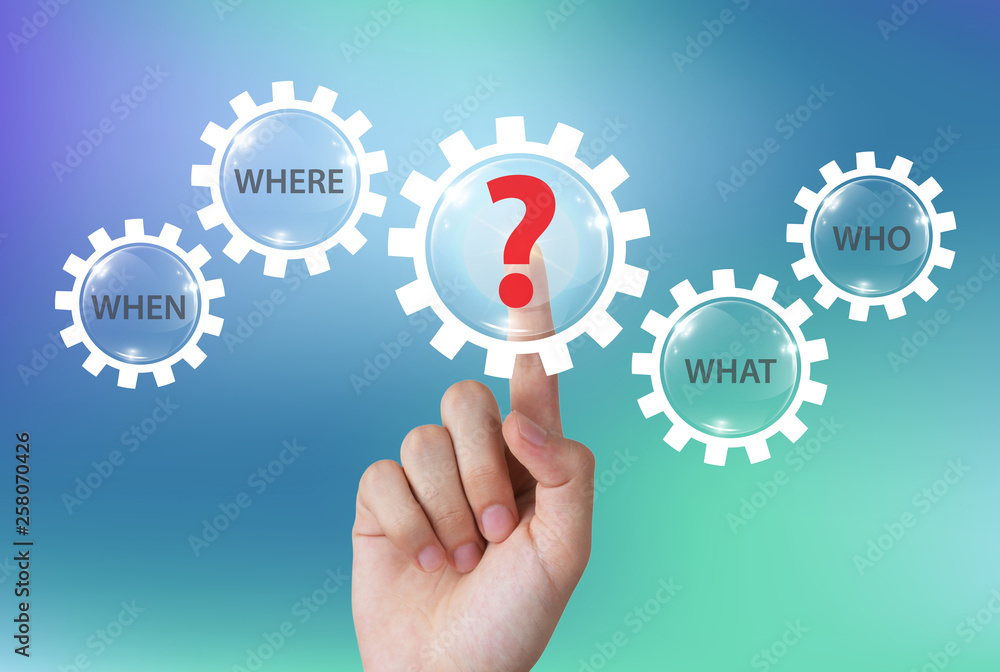Hand pushing question mark icon with question words on touch screen Hand pushing question mark icon with question words on touch screen