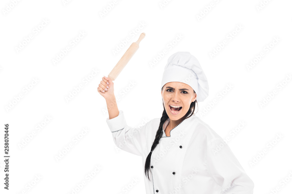 Angry chef in hat holding rolling pin and screaming isolated on white Angry chef in hat holding rolling pin and screaming isolated on white