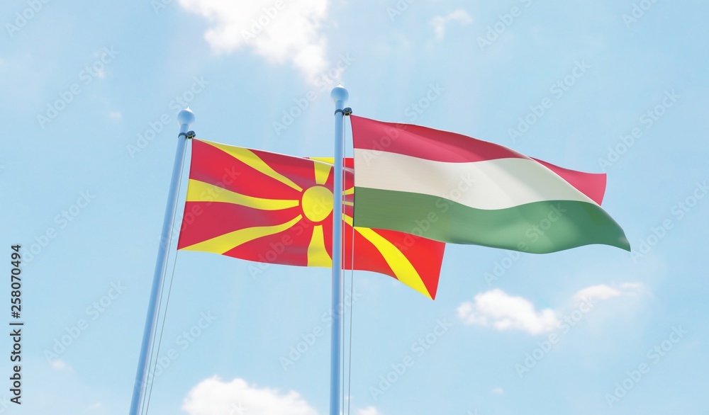 Hungary and Macedonia, two flags waving against blue sky. 3d image
