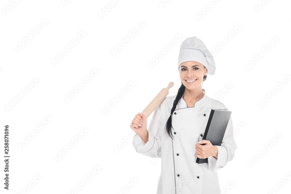 Chef in hat holding rolling pin and book isolated on white Chef in hat holding rolling pin and book isolated on white
