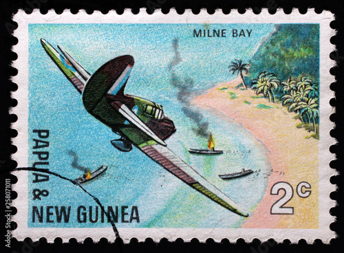 Stamp from Papua New Guinea shows Air attack at Milne Bay, series 25th anniversary of the Pacific War, issued in 1967. photo