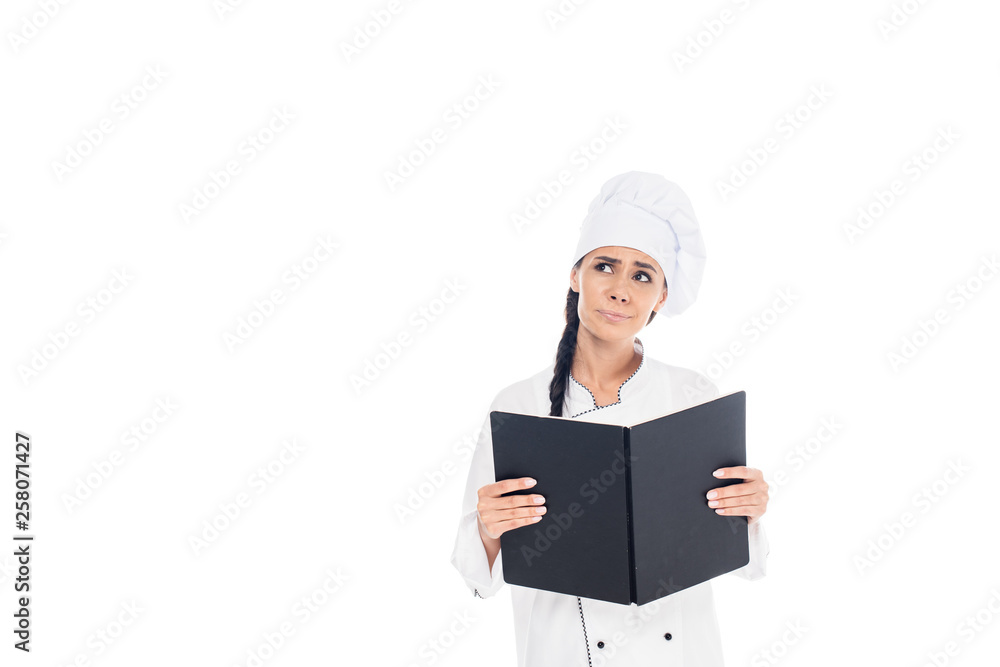 Sad chef in uniform holding black book isolated on white Sad chef in uniform holding black book isolated on white