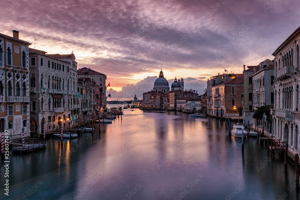 Dawn over the cityscape of Venice, Italy, featuring the silent Canal Grande without boat traffic